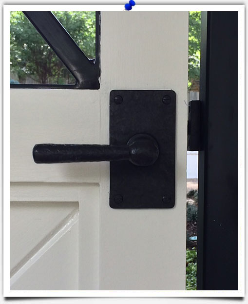 bronze hardware on wood door