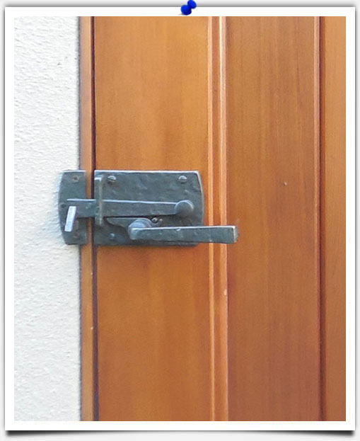 bronze hardware on wood door